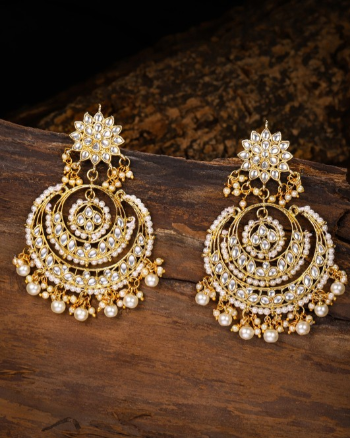 Gold Toned Pearl And Kundan Studded Crescent Shaped Chandbalis